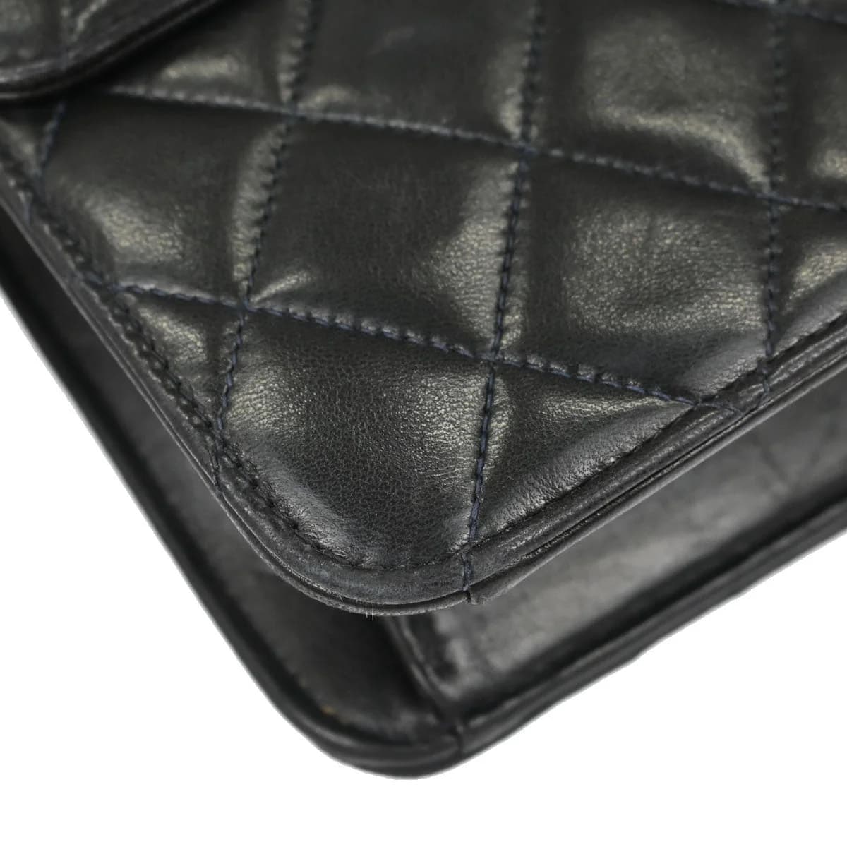 Black quilted leather flap bag with a chain and leather shoulder strap and a turnlock closure