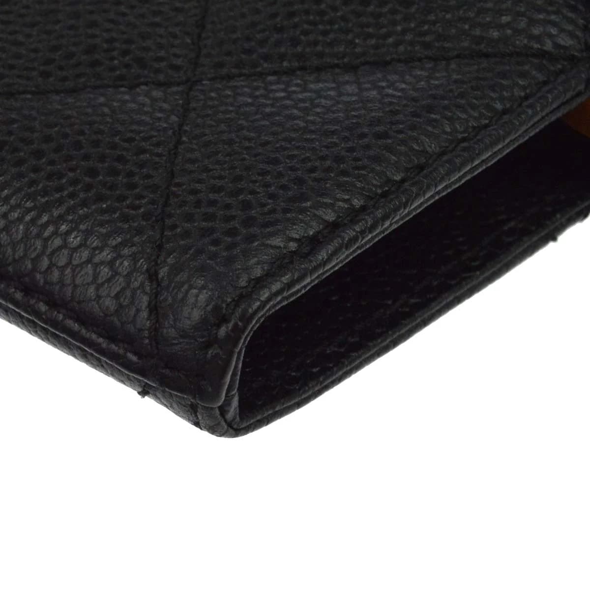 Black grained-leather tote with chain-and-leather shoulder straps.