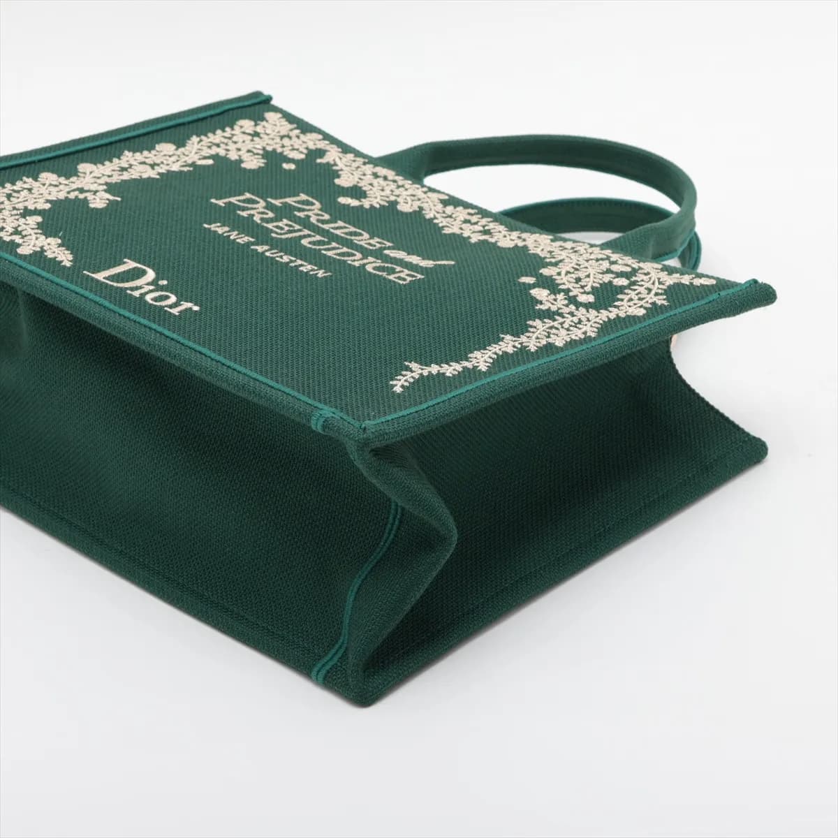 Green patterned canvas tote with star motifs, flat handles and detachable strap.