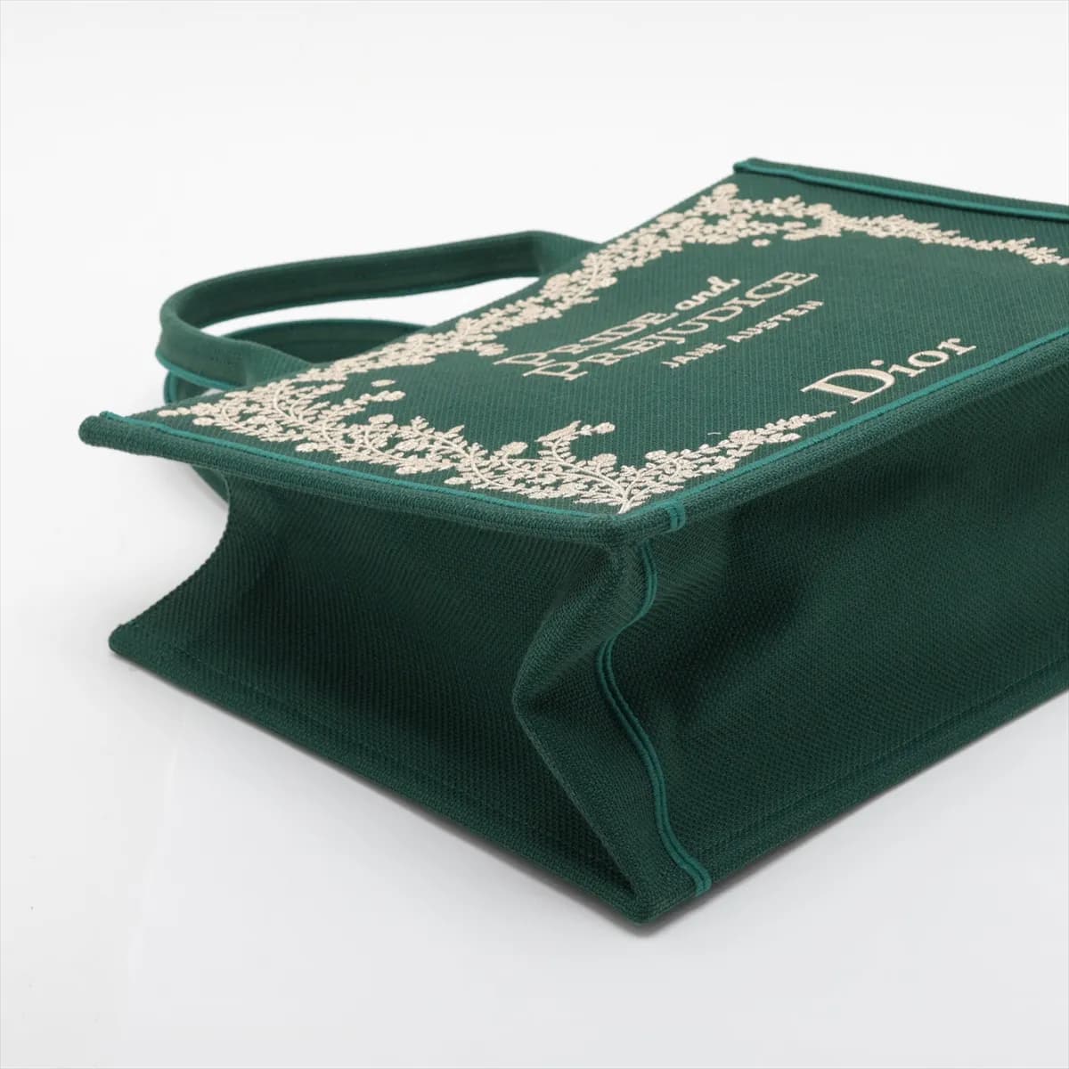 Green patterned canvas tote with star motifs, flat handles and detachable strap.