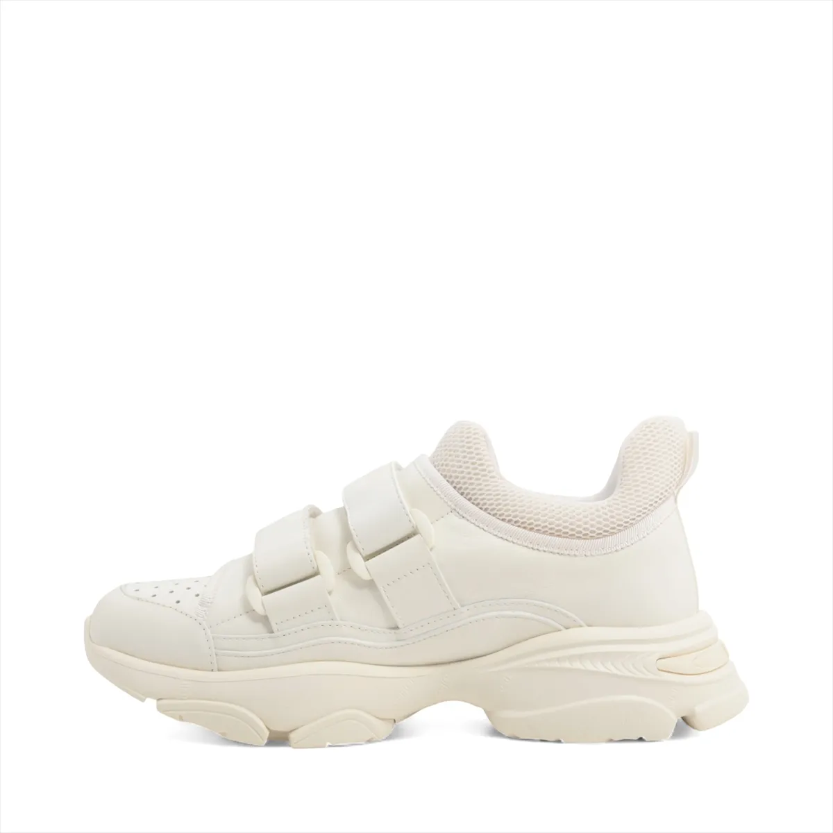 White sneakers with chunky ridged soles, photographed side on