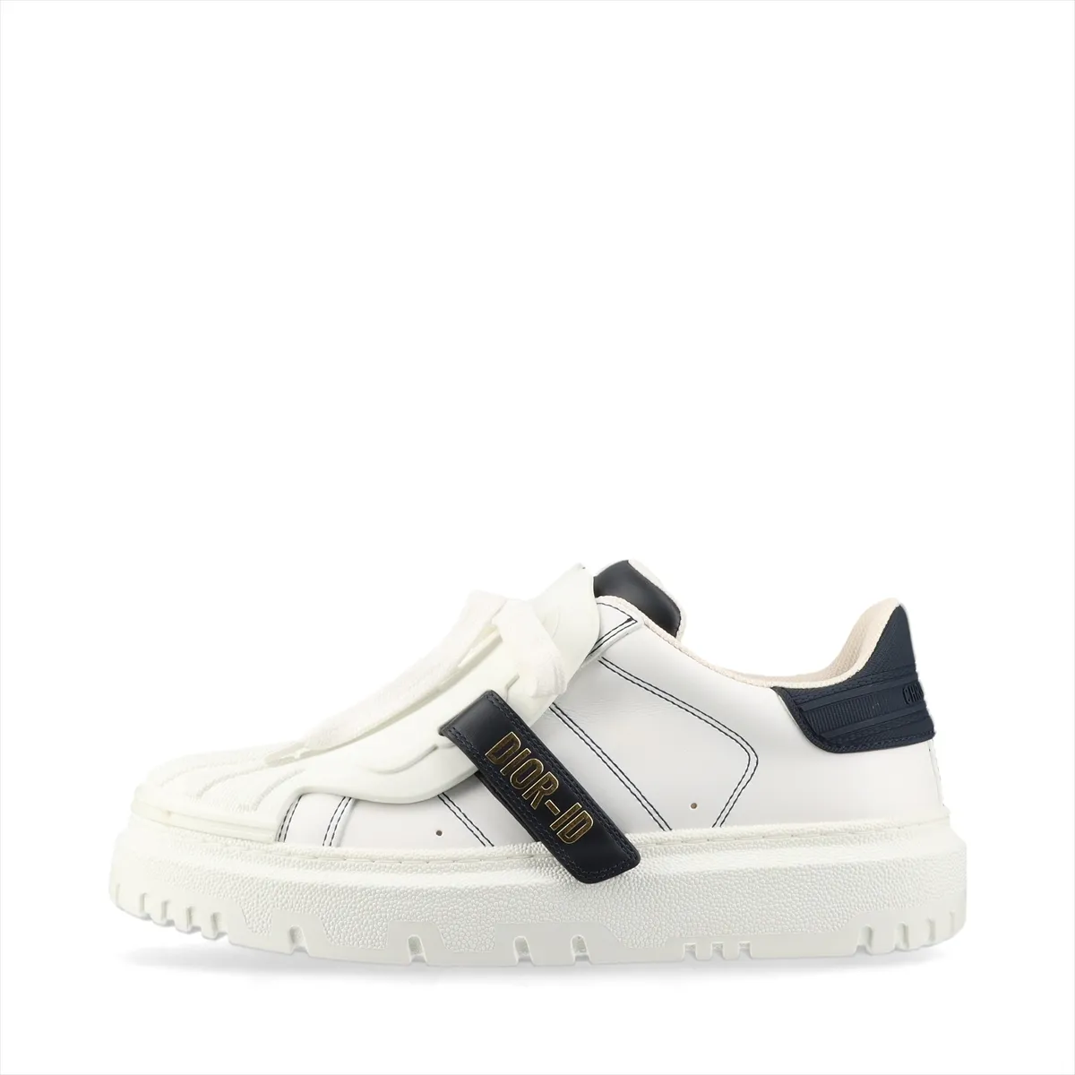 Pair of low-top sneakers in white with navy panels, chunky white sole, photographed on a plain background