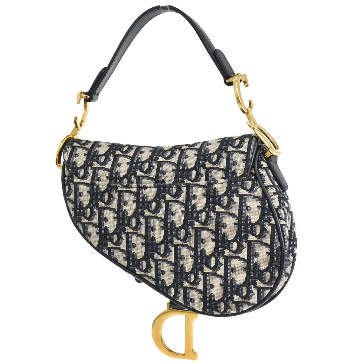 Curved saddle-shaped bag in navy patterned canvas with beige trim and a strap.