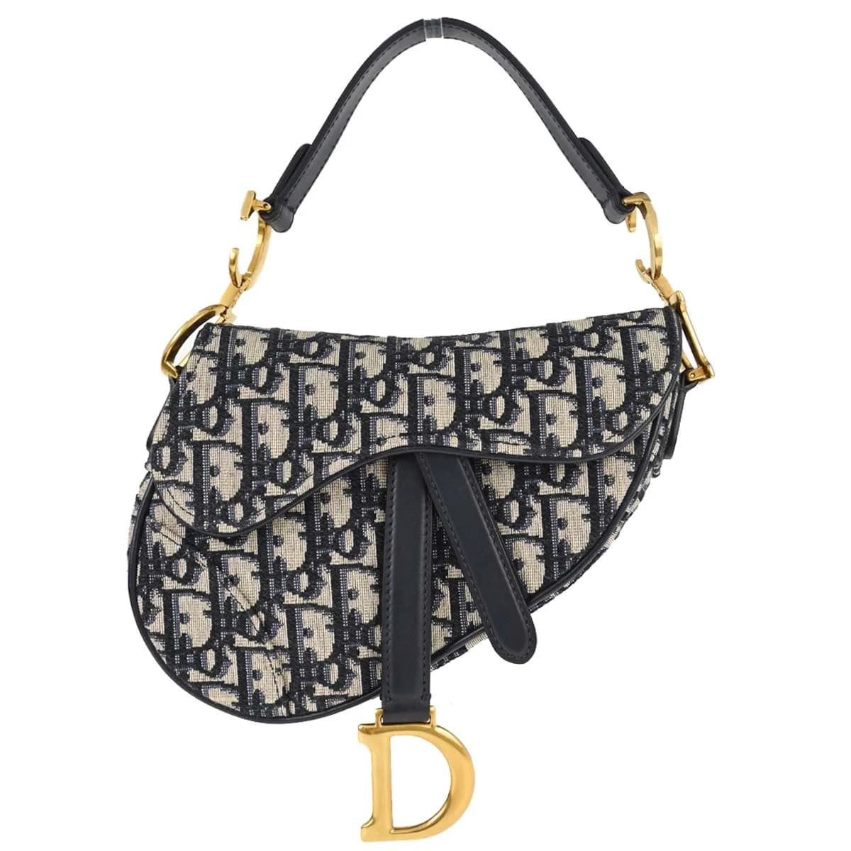 Curved saddle-shaped bag in navy patterned canvas with beige trim and a strap.