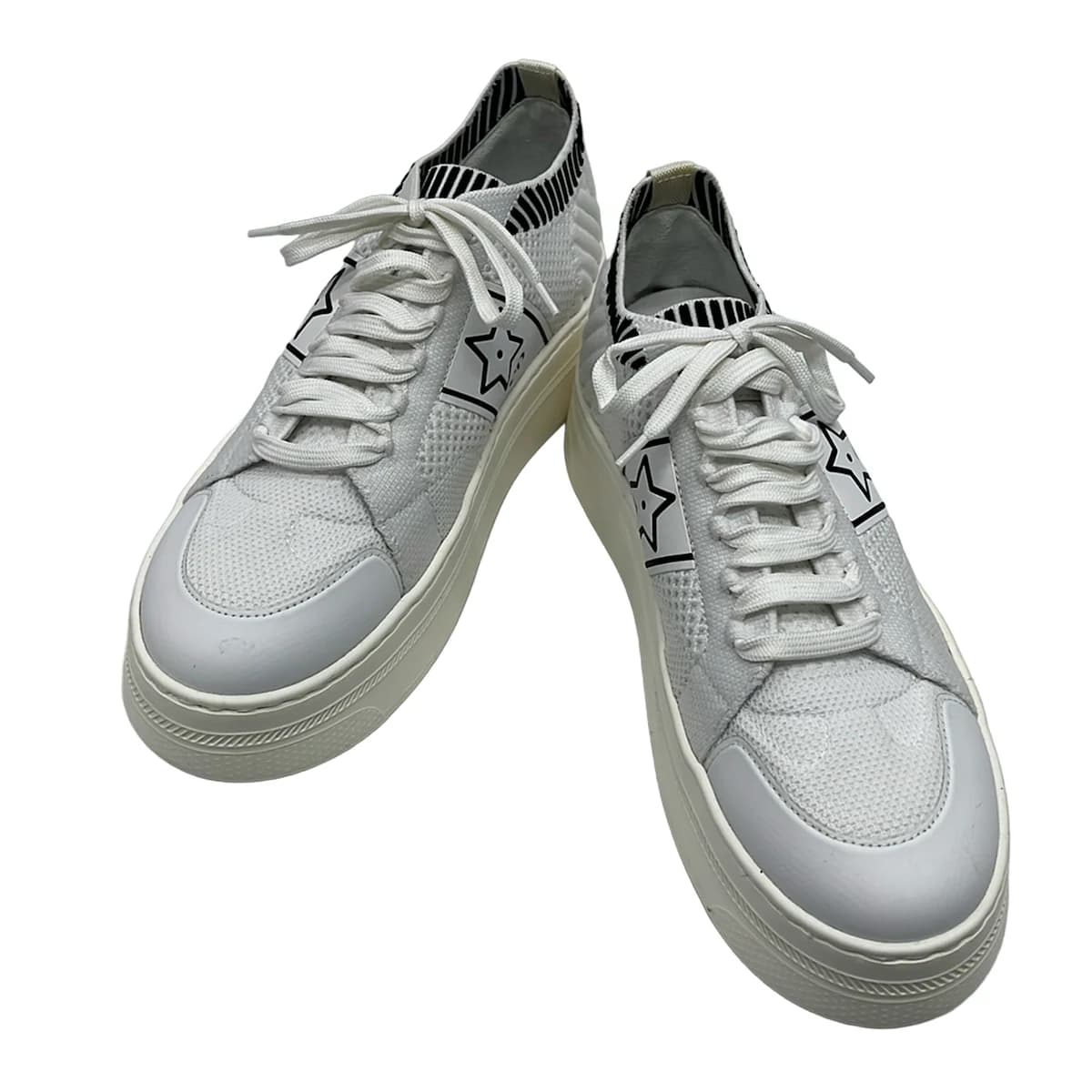Pair of women's low-top sneakers photographed together.