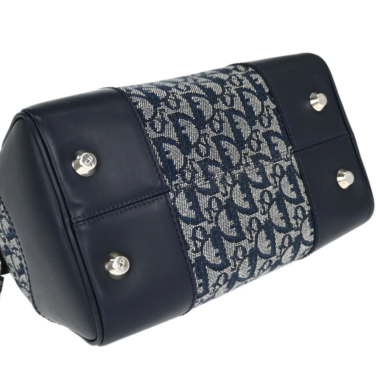Navy monogram-patterned canvas handbag with leather trim and a small padlock.