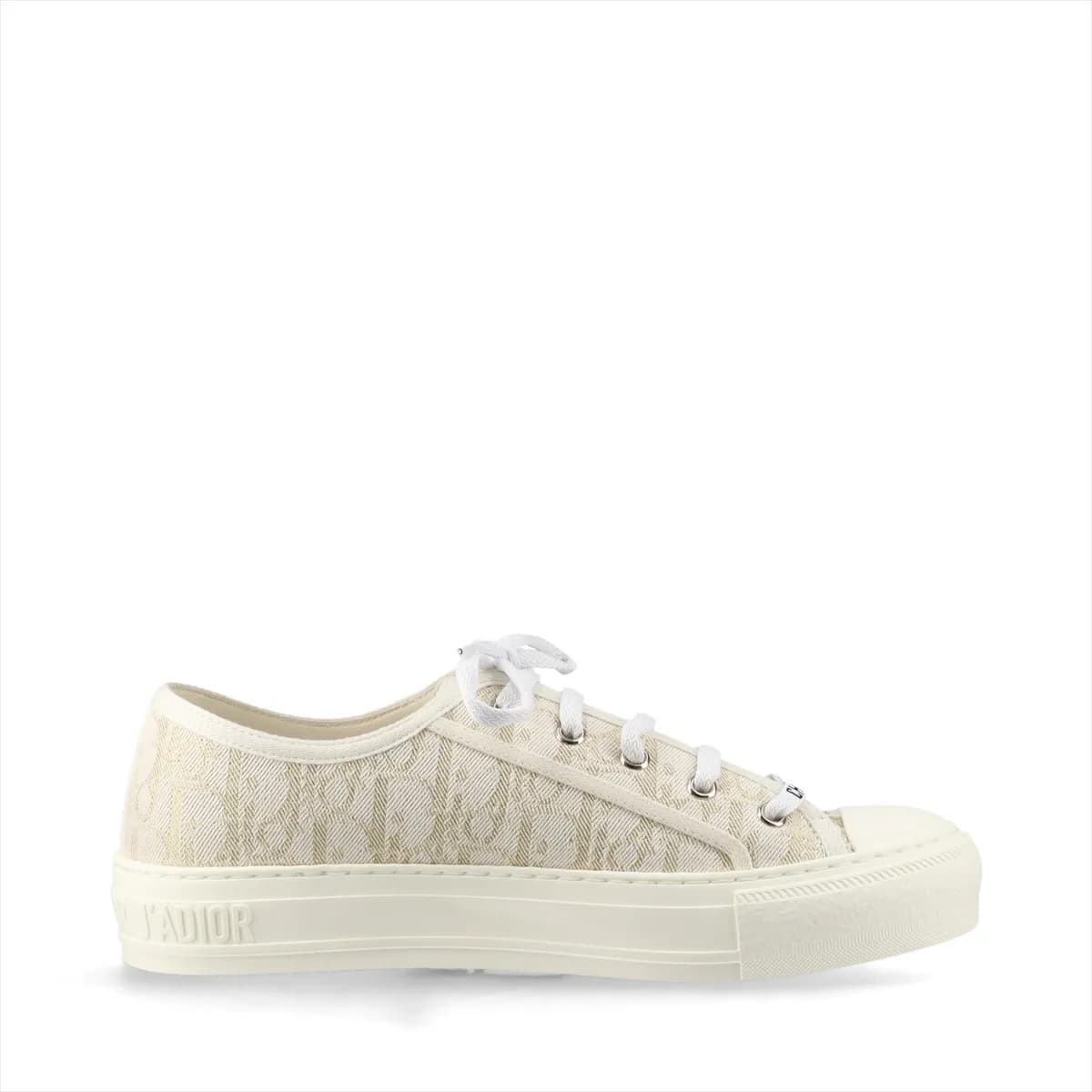 Low-top fabric sneakers with all-over monogram-style pattern in white and gold tones.