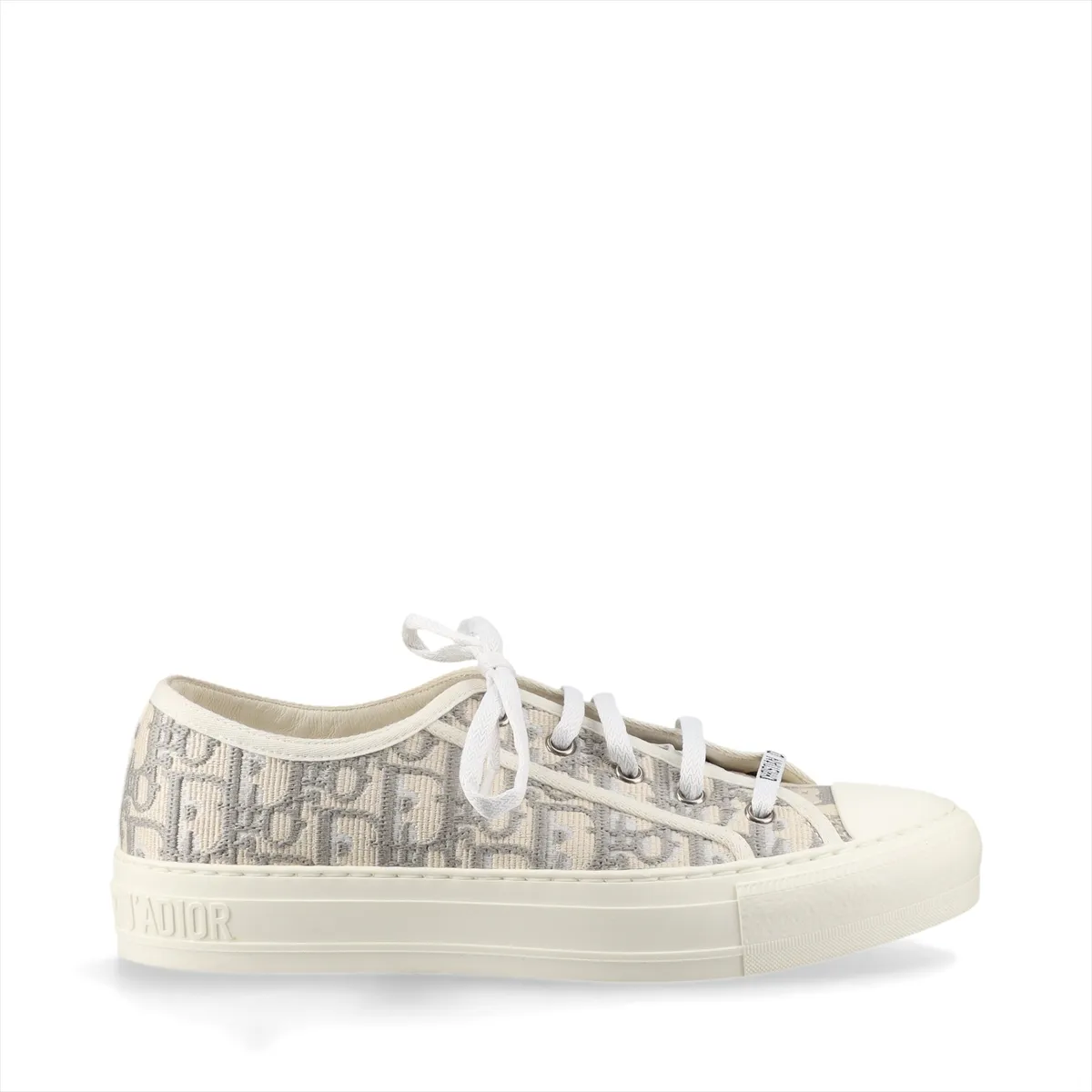 Pair of grey and white patterned fabric sneakers with white rubber soles