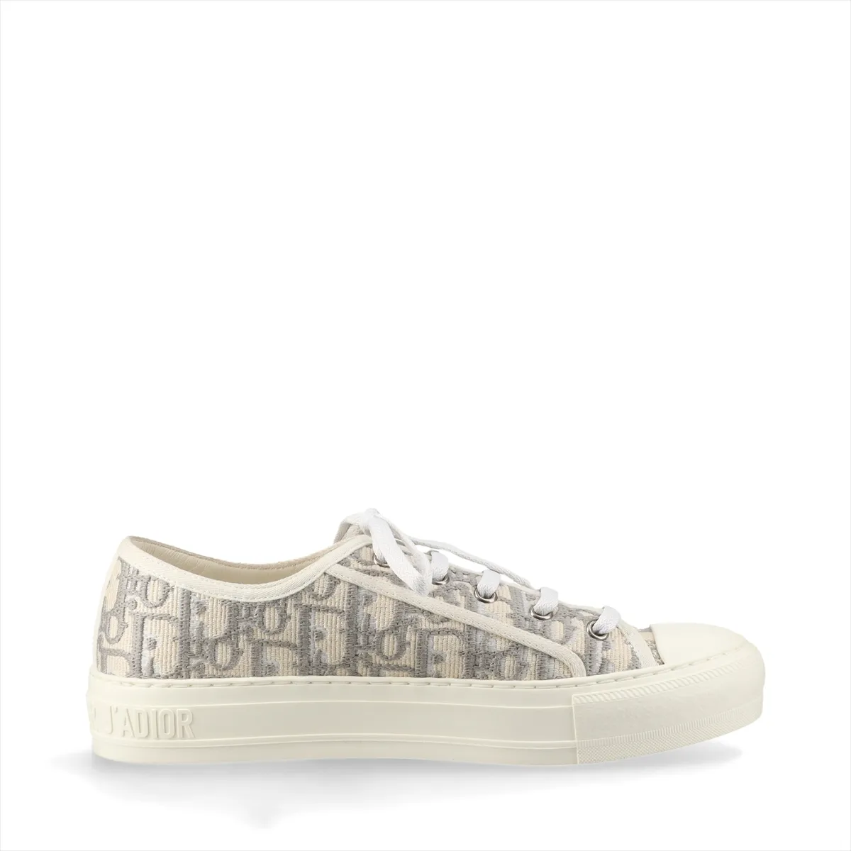 Pair of grey and white patterned fabric sneakers with white rubber soles