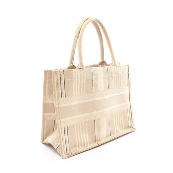 Large flat canvas tote with embroidered patterning and two long top handles.