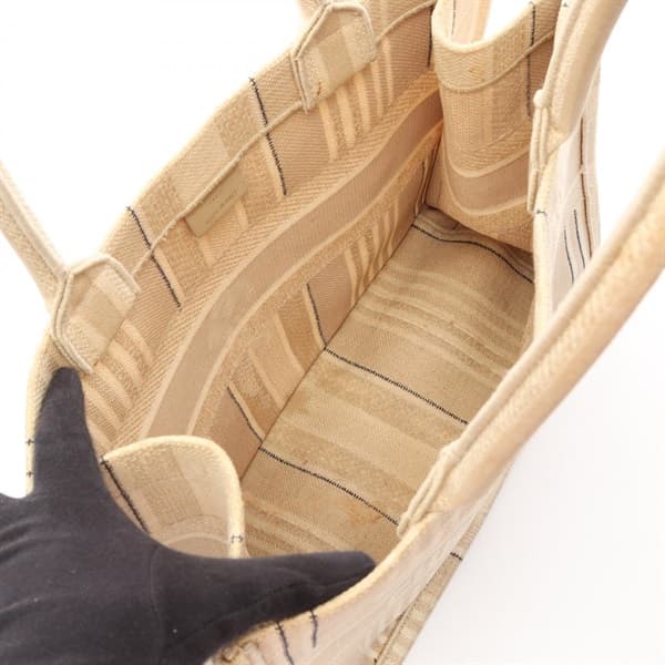 Large flat canvas tote with embroidered patterning and two long top handles.