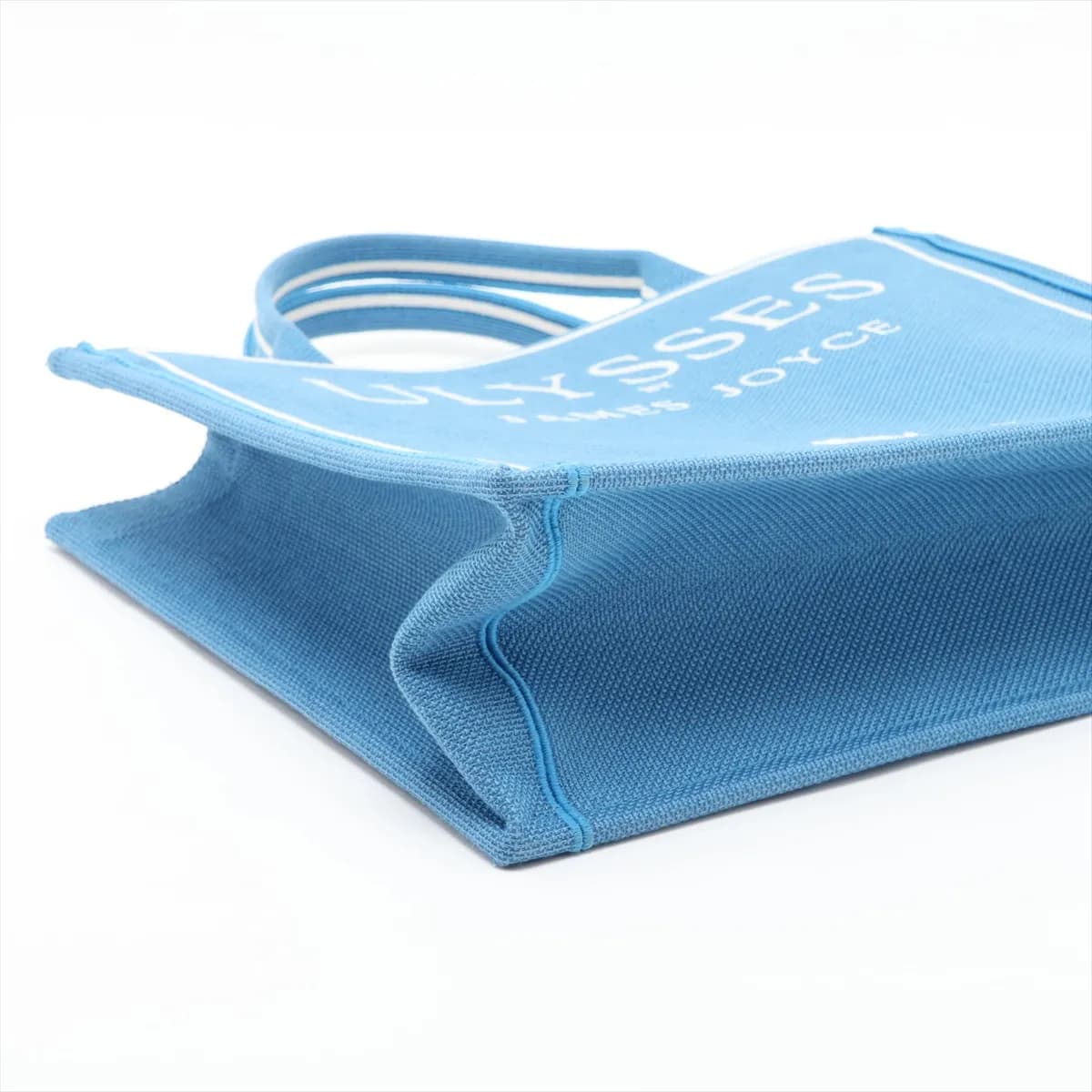 Blue and white patterned canvas tote with star motifs and flat top handles.