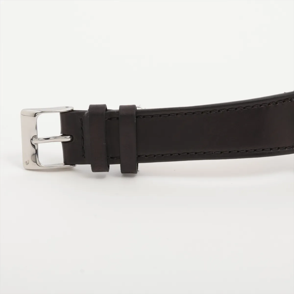 Vintage steel watch with silver dial, date window and applied markers on a leather strap.