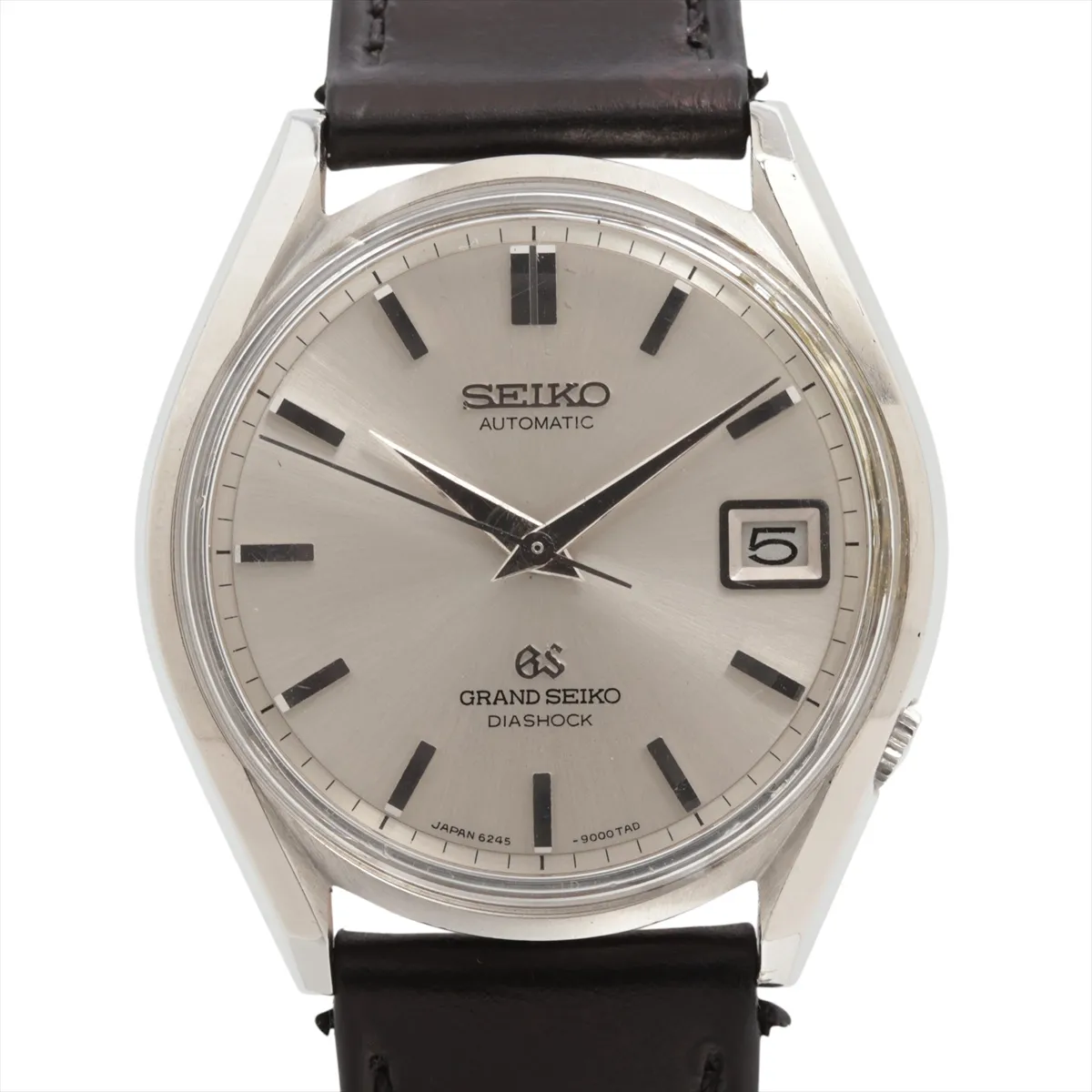 Vintage steel watch with silver dial, date window and applied markers on a leather strap.