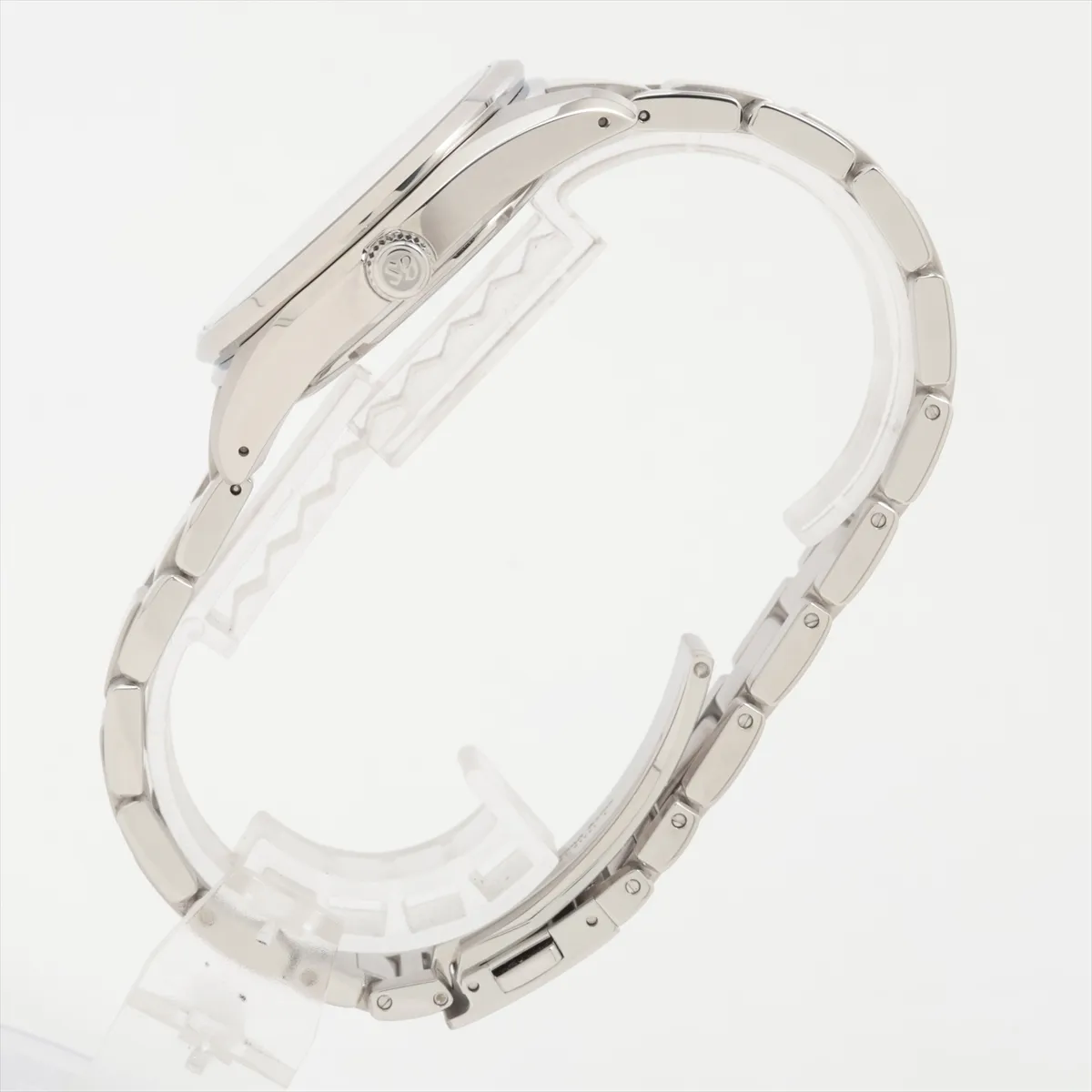 Polished steel watch with bright silver dial, sharp faceted markers and integrated bracelet.