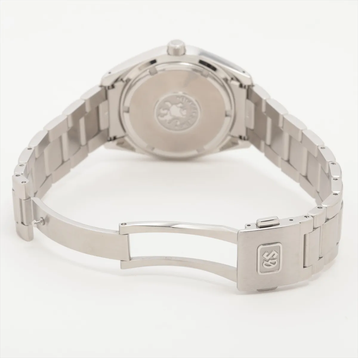 Polished steel watch with bright silver dial, sharp faceted markers and integrated bracelet.
