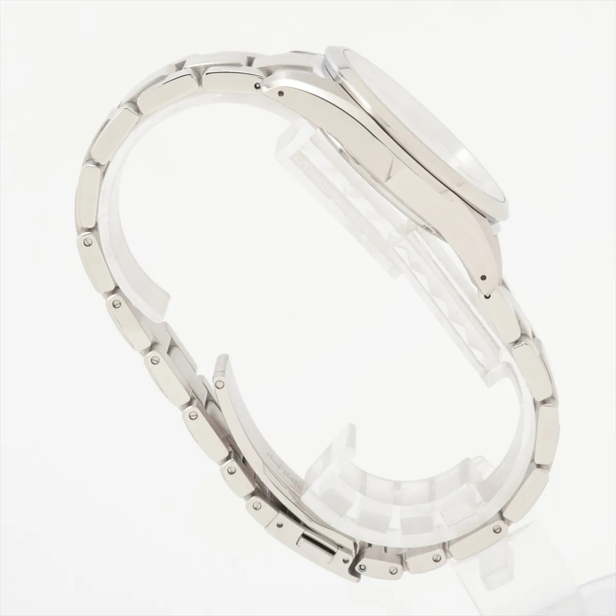 Polished steel watch with bright silver dial, sharp faceted markers and integrated bracelet.