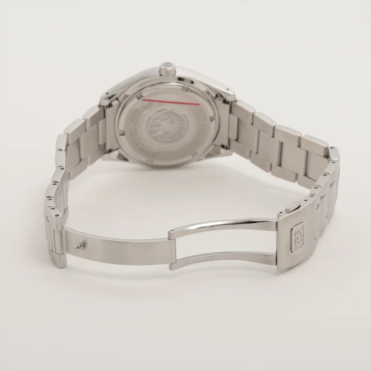 Steel wristwatch with blue dial, date aperture at three o'clock and brushed steel bracelet.