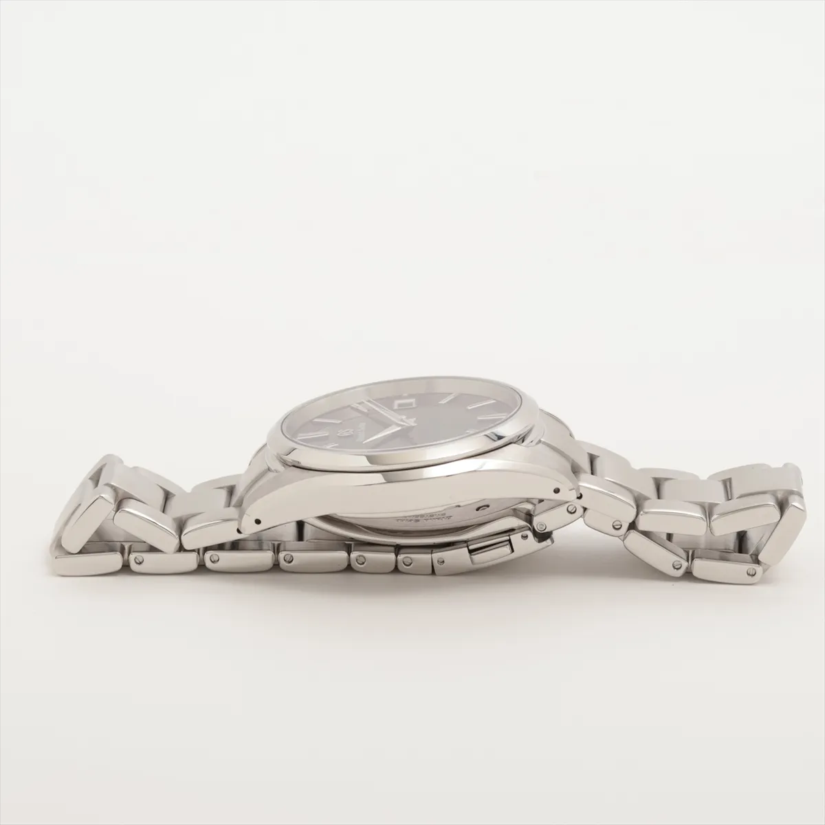 Steel wristwatch with blue dial, date aperture at three o'clock and brushed steel bracelet.