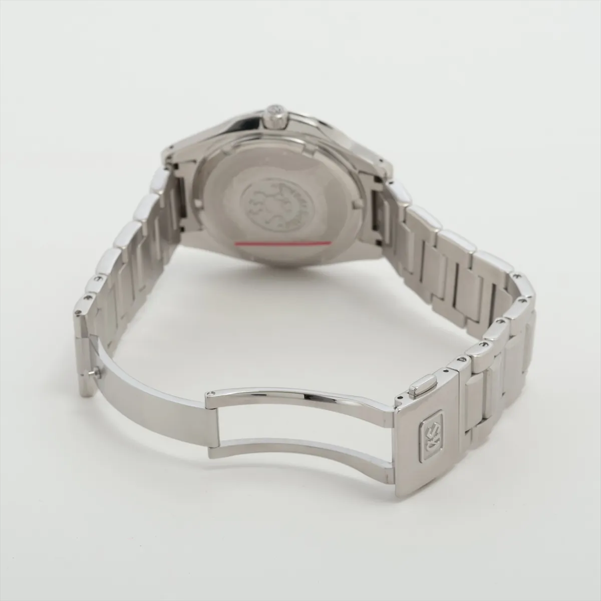 Steel wristwatch with deep blue dial, applied baton markers, date window and steel bracelet.