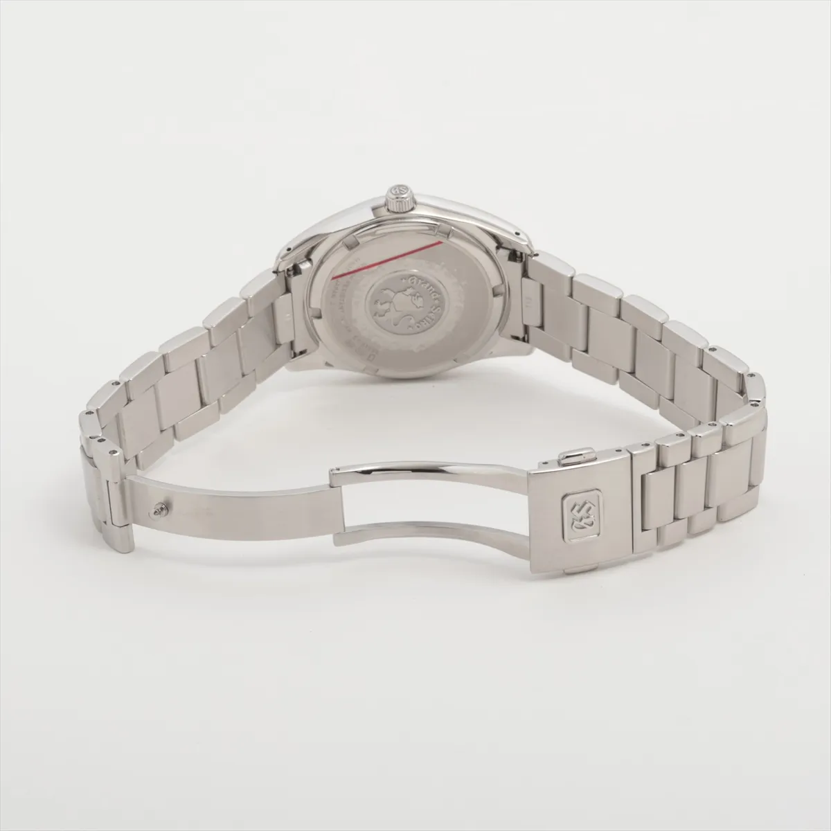Steel wristwatch with black dial, baton indexes and matching steel bracelet.