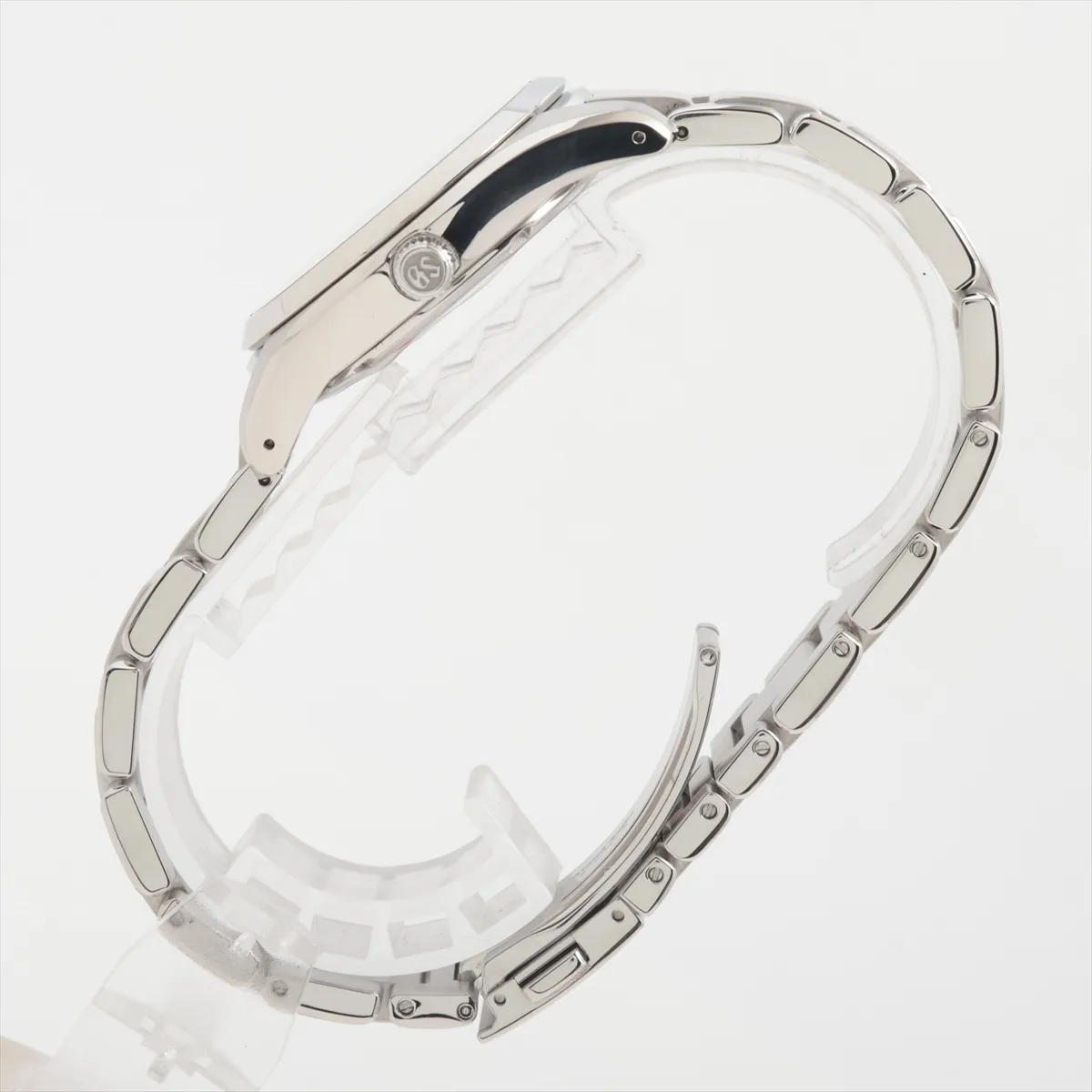 Steel wristwatch with black dial, baton indexes and matching steel bracelet.