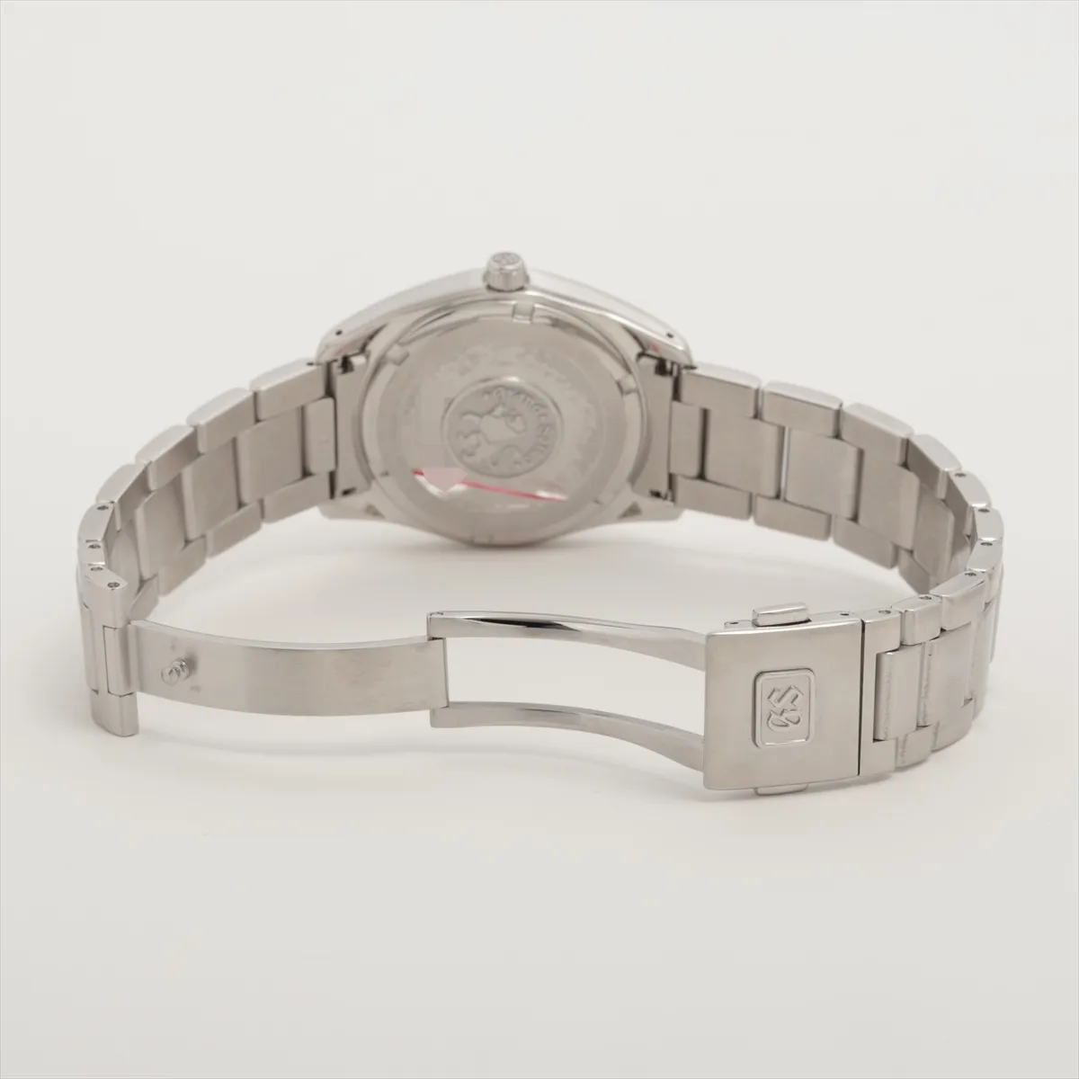 Stainless steel wristwatch with a silver dial, baton indices and a three-link bracelet.