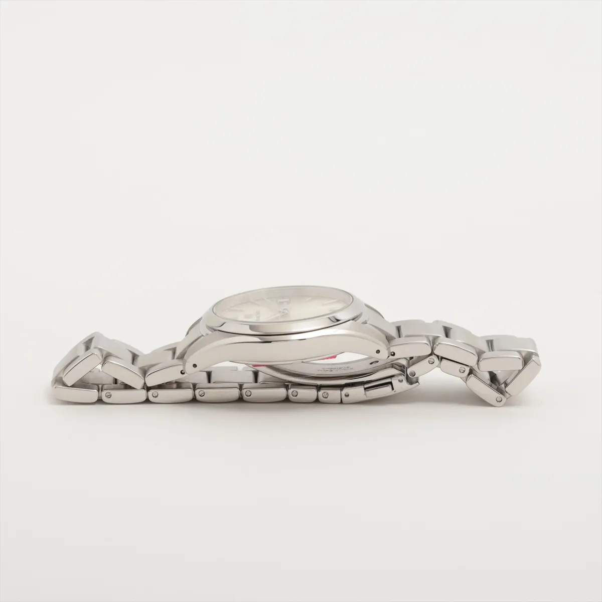 Stainless steel wristwatch with a silver dial, baton indices and a three-link bracelet.