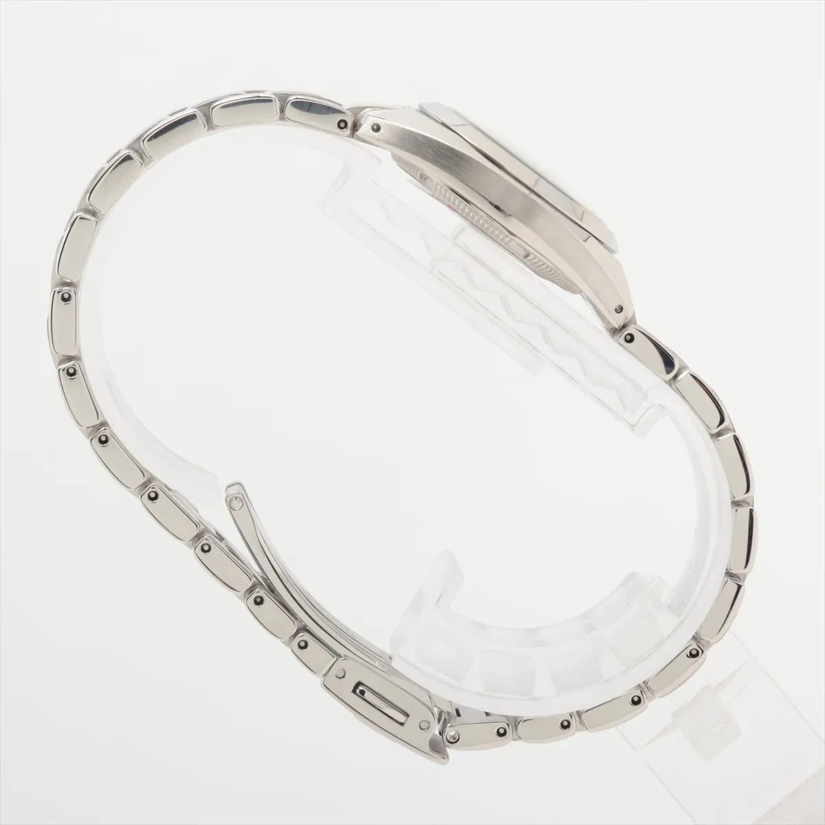 Slim steel watch with shimmering white dial and polished bracelet.