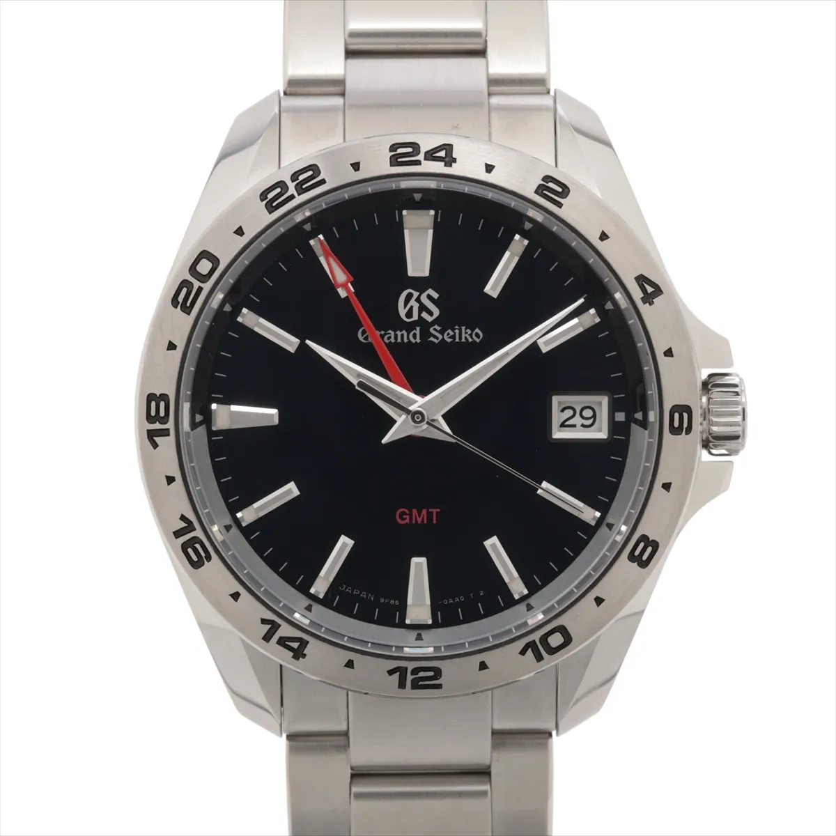 Steel sports watch with deep blue dial, GMT hand and date window on a brushed bracelet.