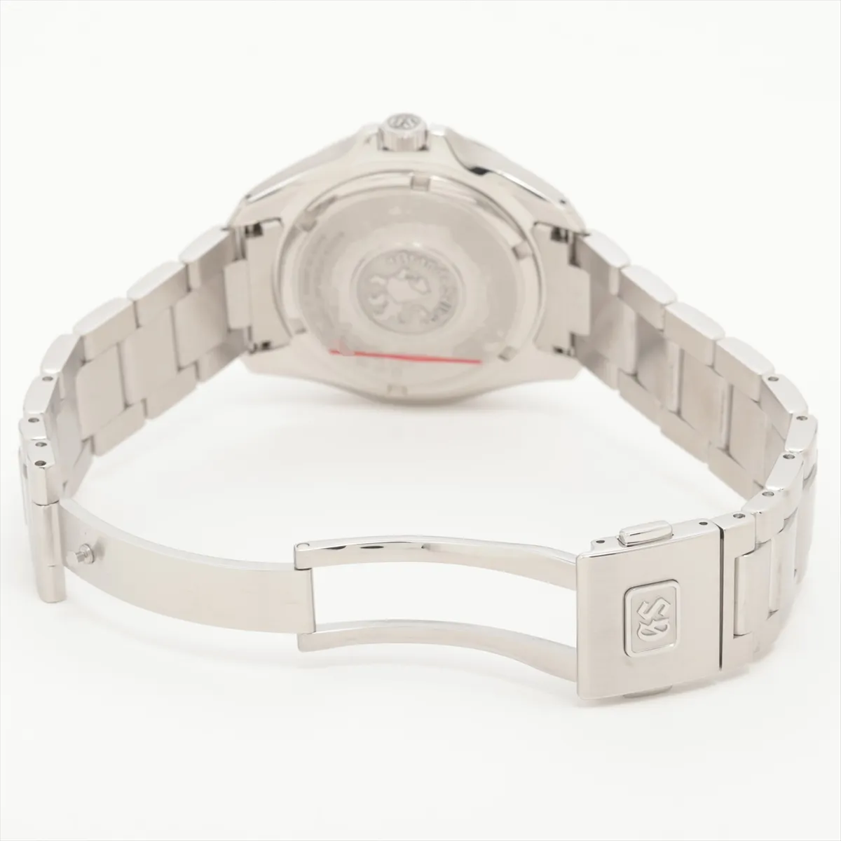 Steel sports watch with deep blue dial, GMT hand and date window on a brushed bracelet.