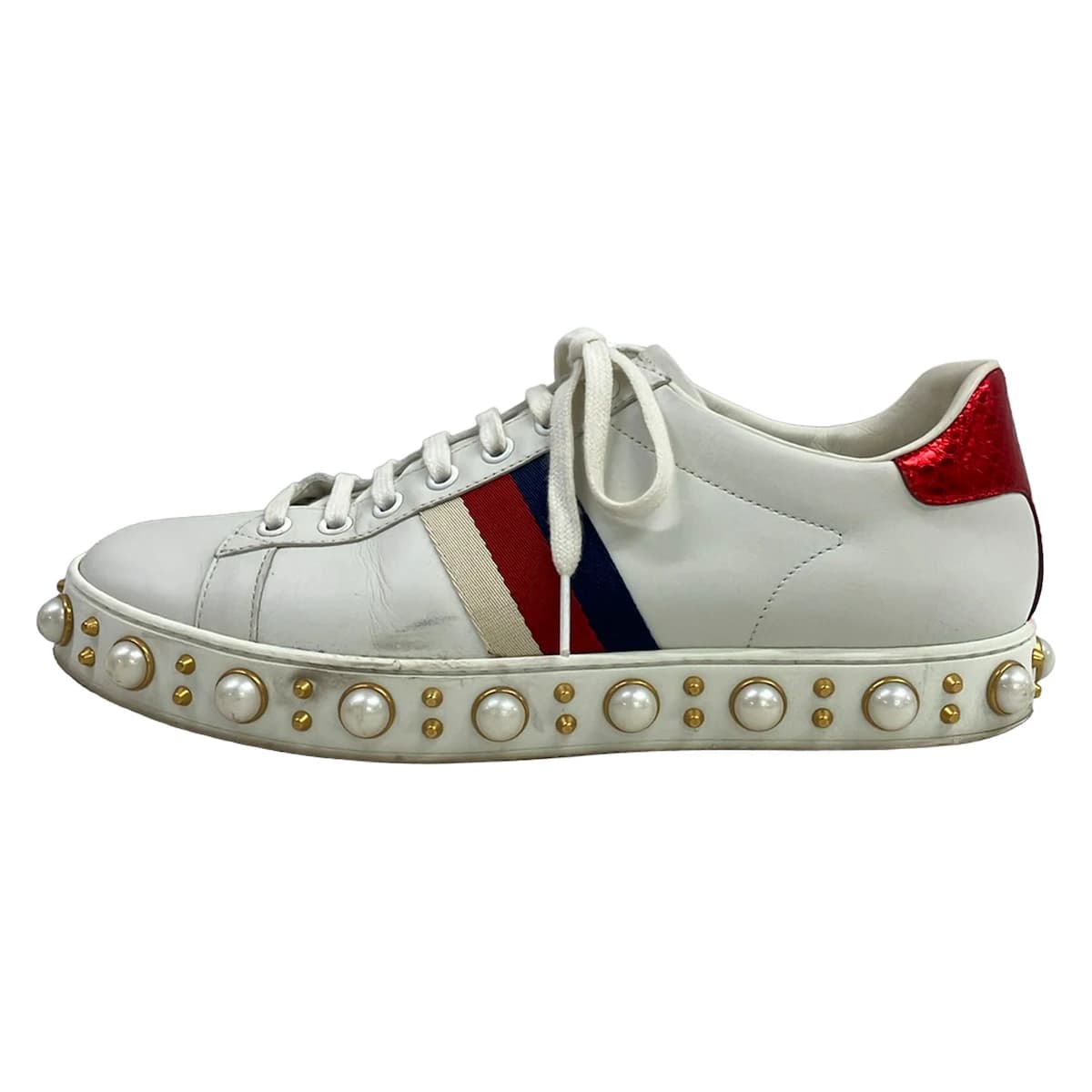 Low-top sneakers in white with burgundy and navy side stripes.
