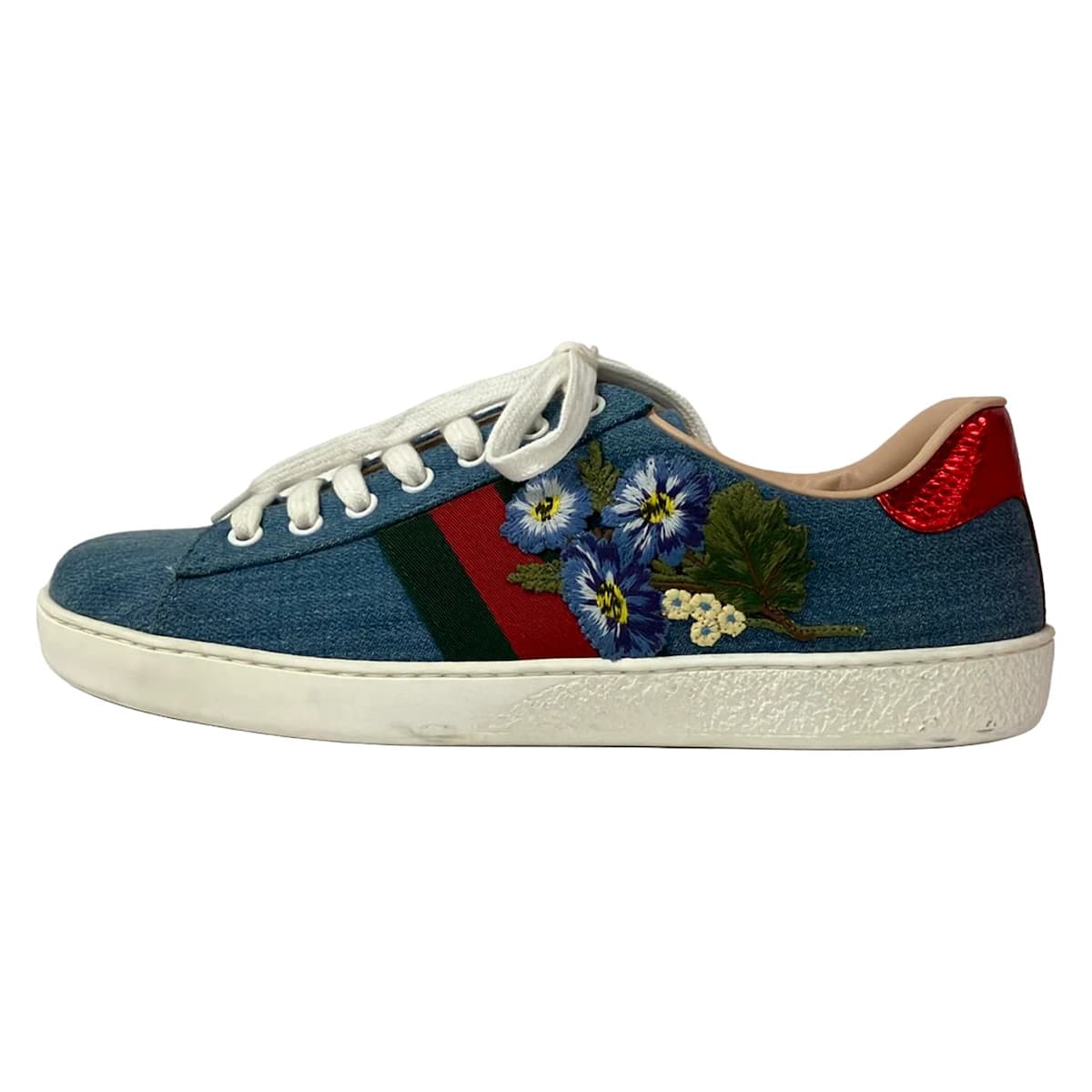 Pair of low-top shoes with floral embroidery across the upper, photographed against a plain background.
