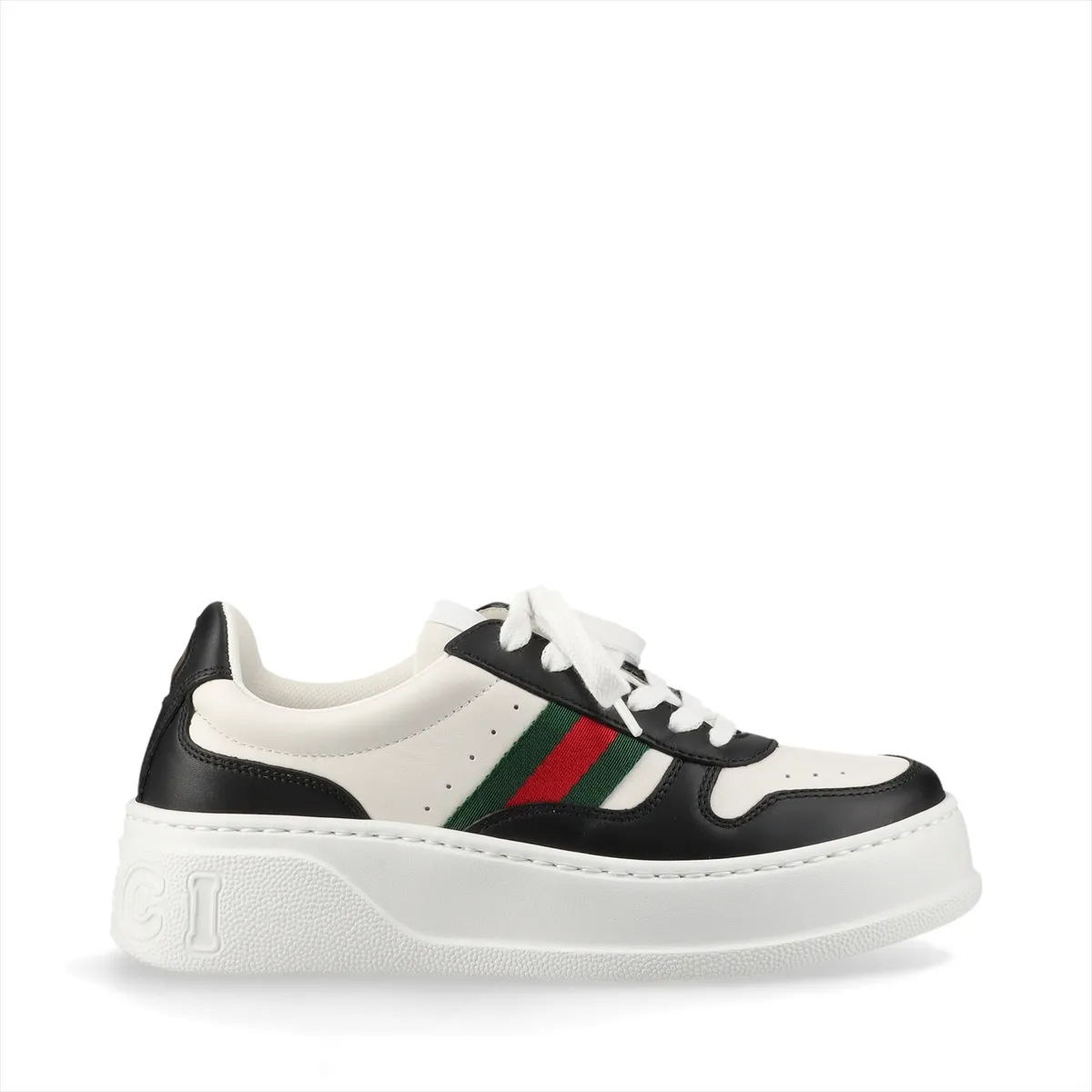 Pair of thick-soled low-top sneakers in black and white with a red and green striped band.