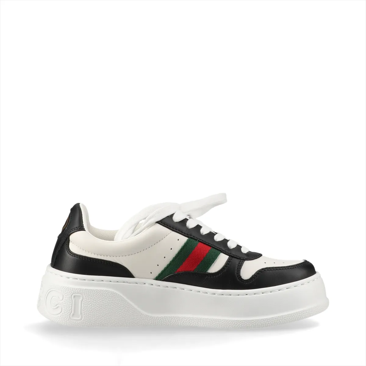 Pair of thick-soled low-top sneakers in black and white with a red and green striped band.
