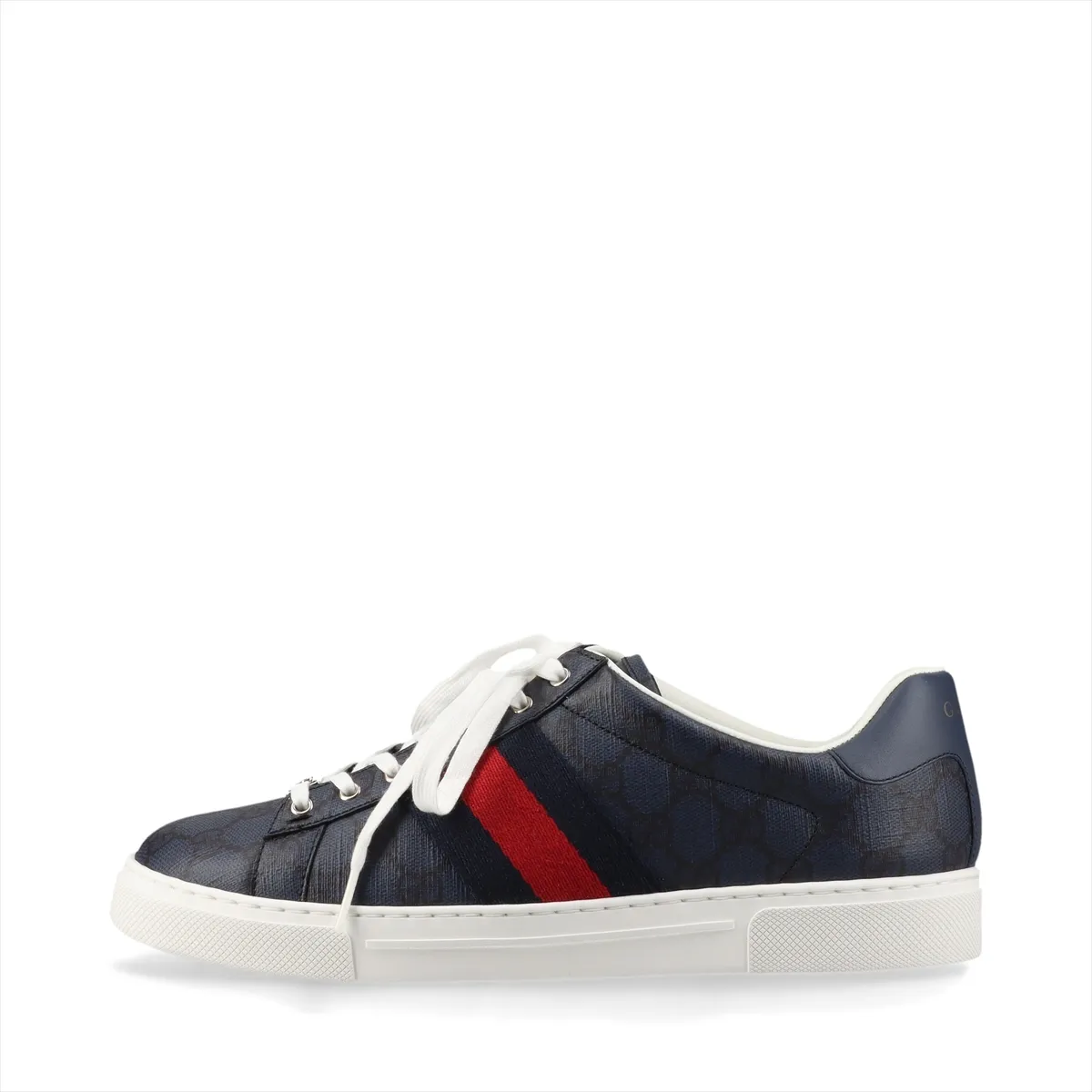 Pair of low-top sneakers in patterned fabric with leather trim and a red-and-green stripe.