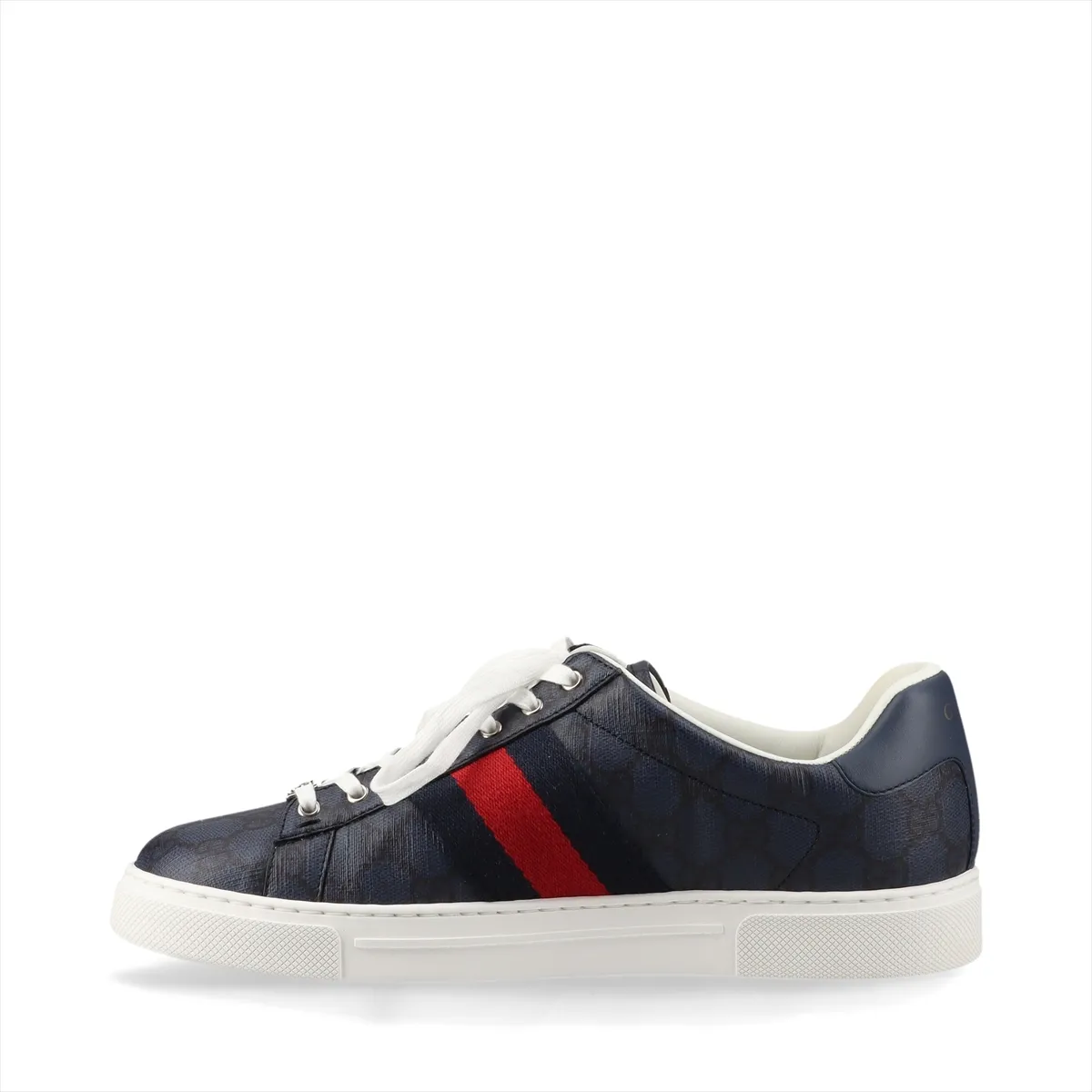 Pair of low-top sneakers in patterned fabric with leather trim and a red-and-green stripe.