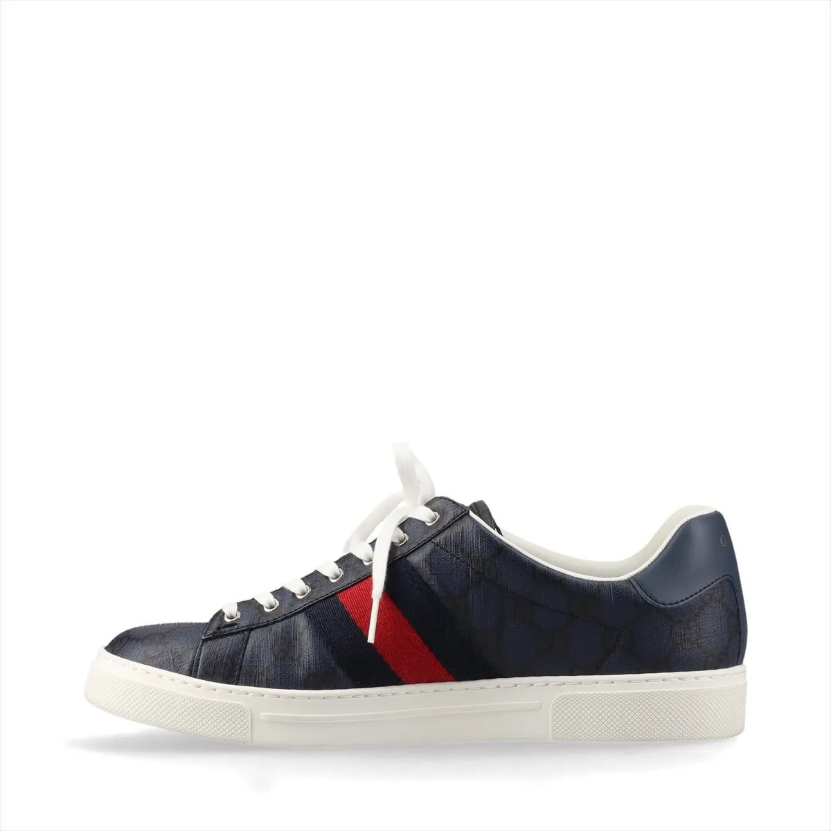 Pair of low-top navy sneakers with a red and green striped band and monogram-pattern panels.