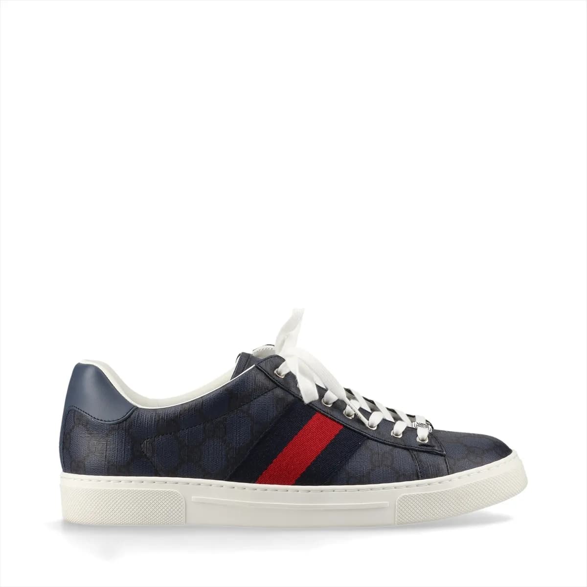 Pair of low-top navy sneakers with a red and green striped band and monogram-pattern panels.