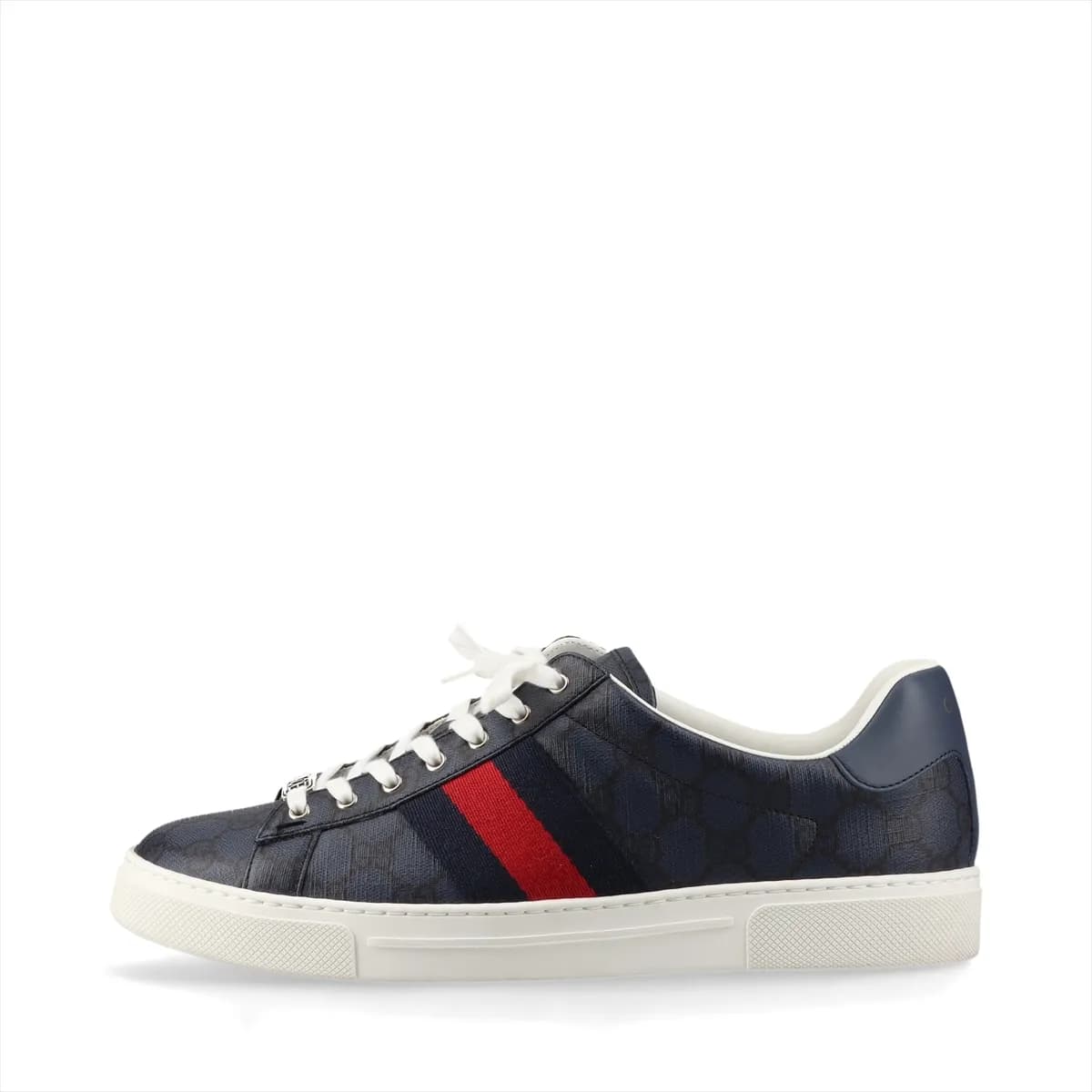 Pair of low-top navy sneakers with a red and green striped band and monogram-pattern panels.