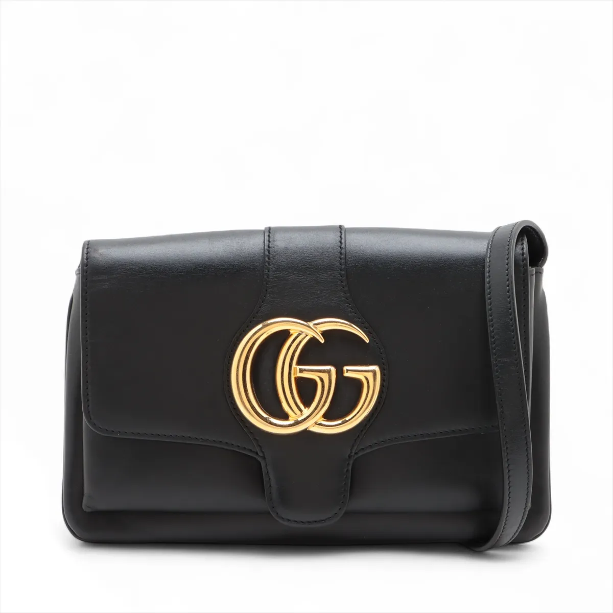 Product photograph of a small black leather bag with a shoulder strap.
