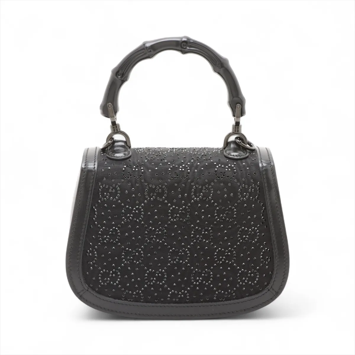 Small structured black handbag with a curved bamboo top handle and a jewelled clasp.