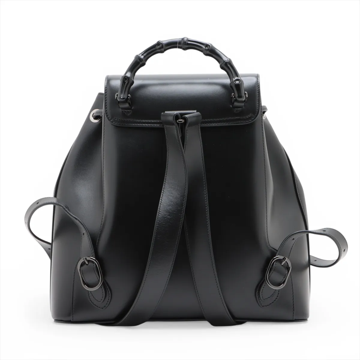 Product photograph of a black leather backpack with bamboo hardware.