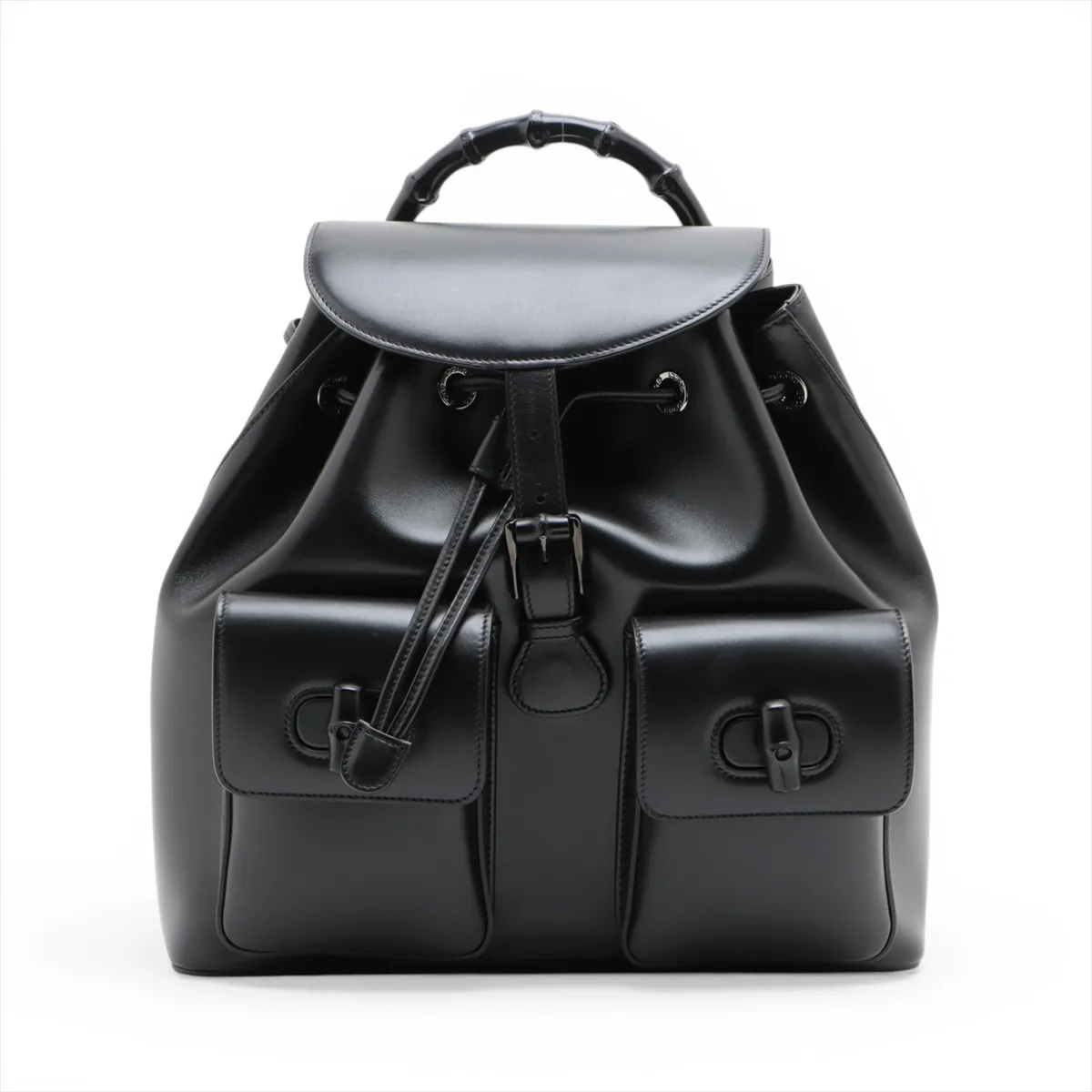 Product photograph of a black leather backpack with bamboo hardware.