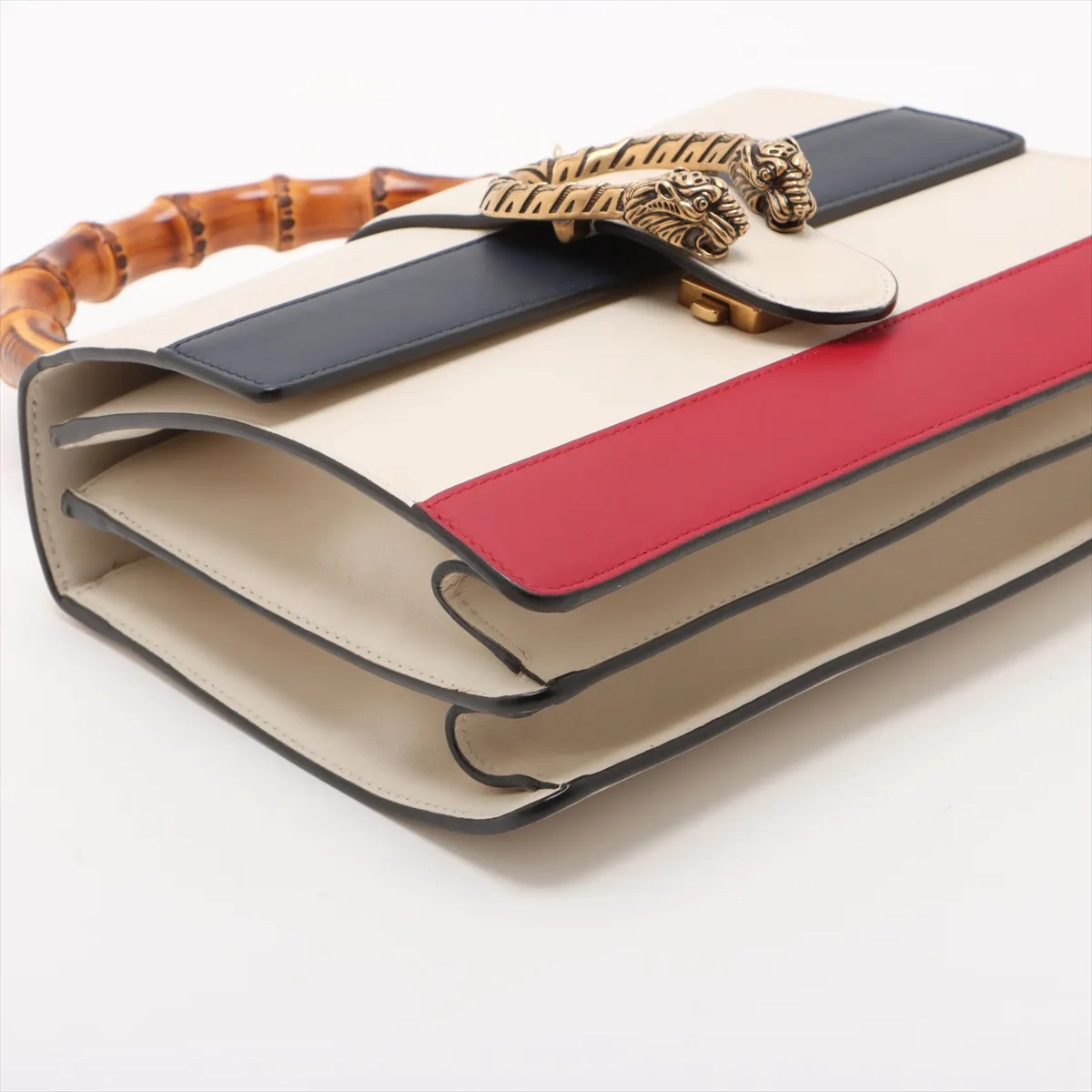 Multicolour leather handbag with bamboo-accented hardware, a top handle and a detachable strap.