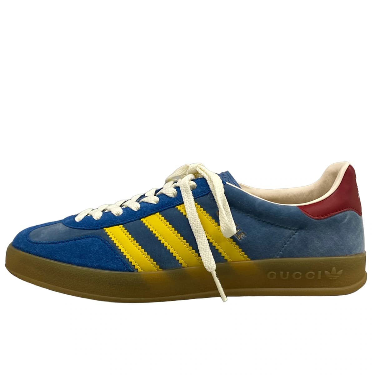 Low-top sneakers in blue with yellow and red trim detailing.