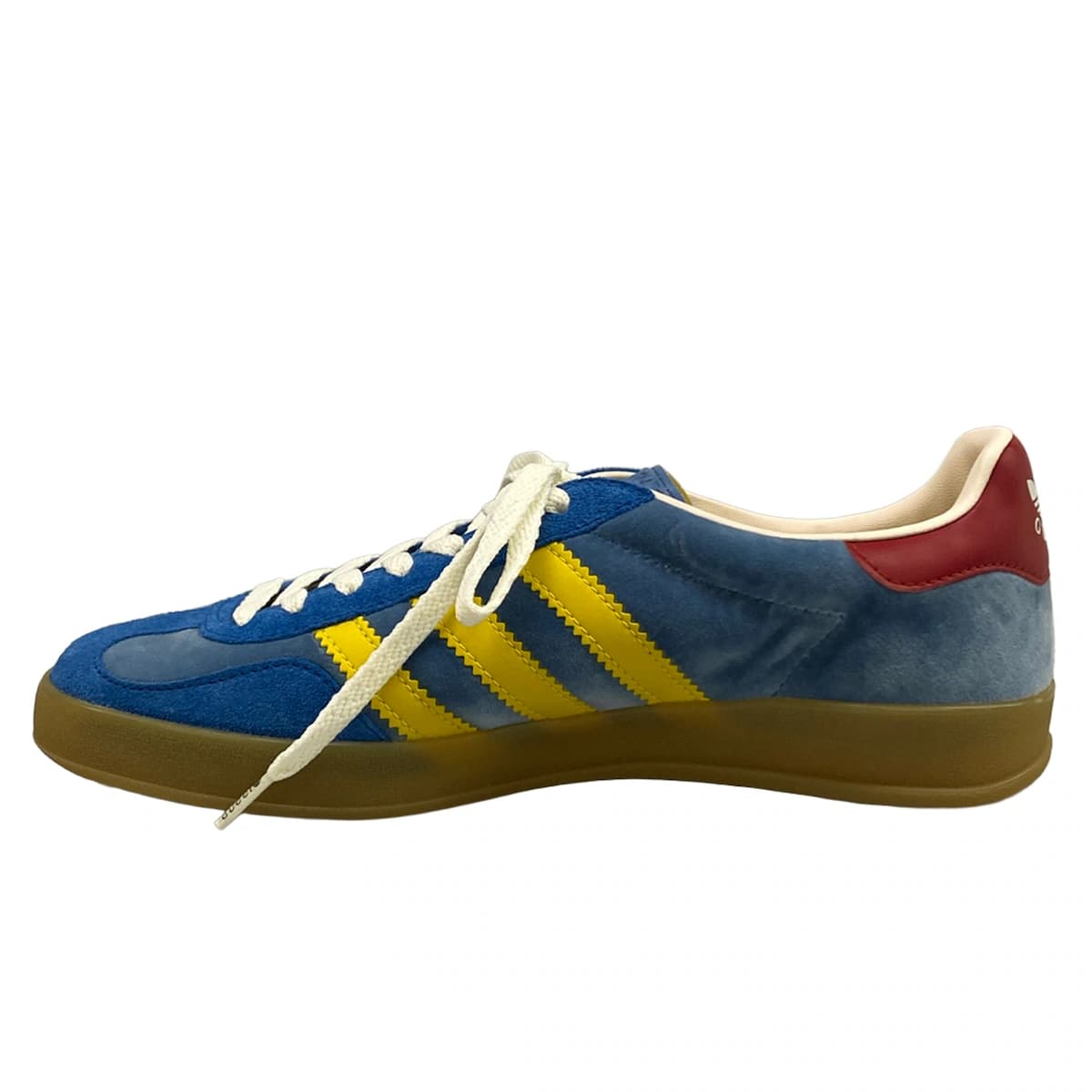 Low-top sneakers in blue with yellow and red trim detailing.