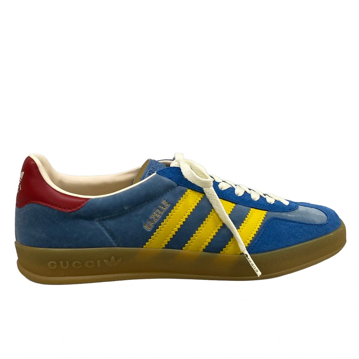 Low-top sneakers in blue with yellow and red trim detailing.