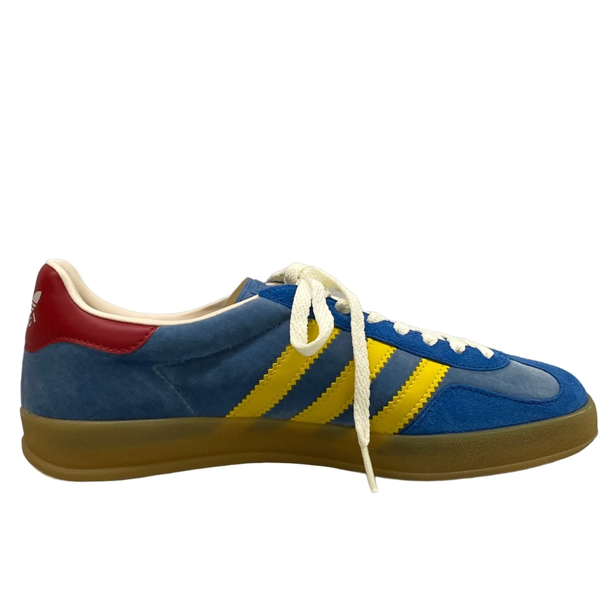 Low-top sneakers in blue with yellow and red trim detailing.