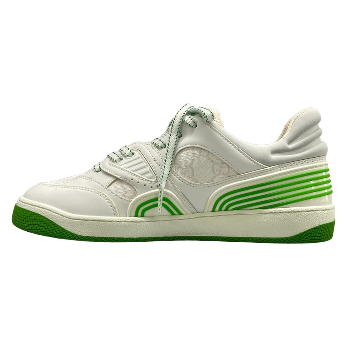 Pair of white low-top shoes with light green trim and a monogram-patterned panel.